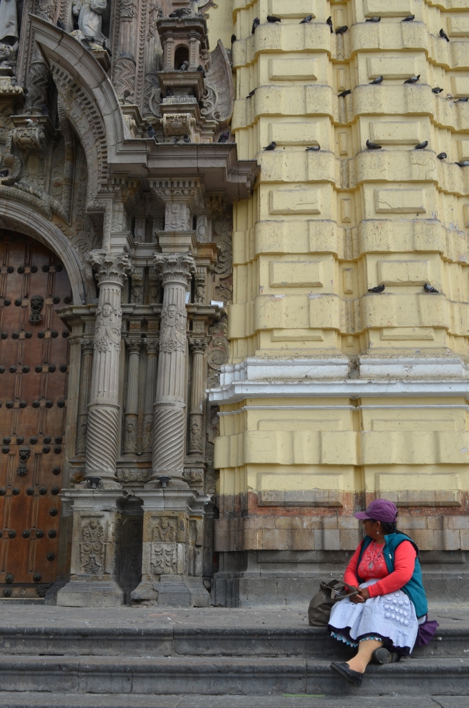 A local woman sitting outside in front of the church. 